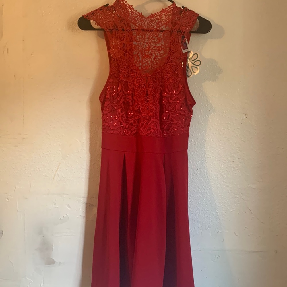 Large red dress. Sequin detail on top. Runs more like a medium in my opinion.